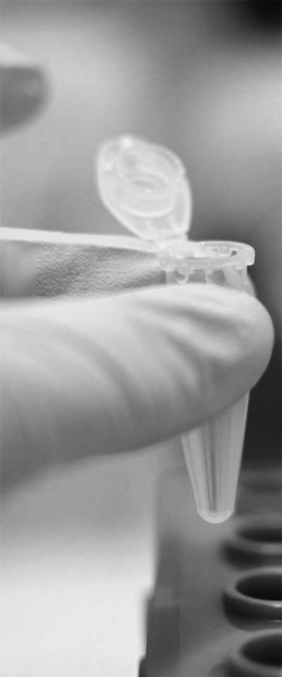 hand holding plastic vial